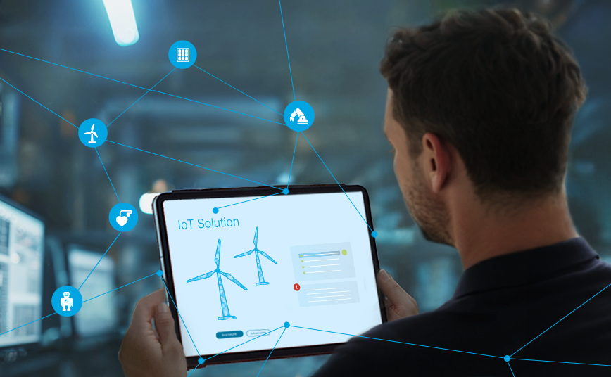 Keyvisual IoT: Mann schaut auf ein Tablet mit vernetzten Windrädern